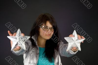 Fashion girl in silver jacket with two stars