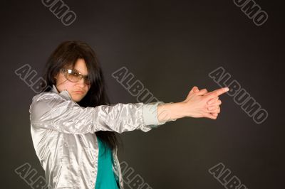 Fashion girl pointing her hand like a gun
