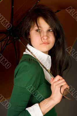 Serious looking girl under umbrella