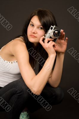 Attractive fashion girl with camera