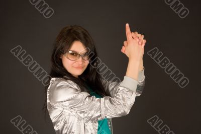 Smiling girl pointing her hands like a gun