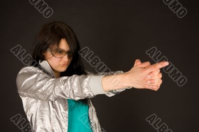 Fashion girl pointing her hands like a gun