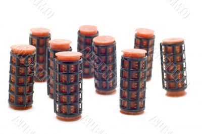 Red hair-rollers on white