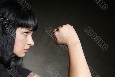 woman clenches fist