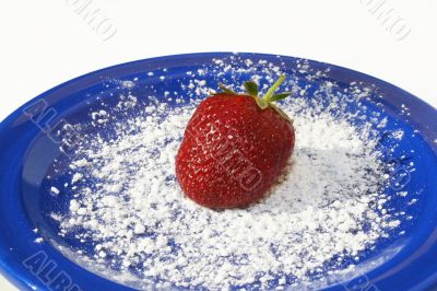 Single strawberry on plate
