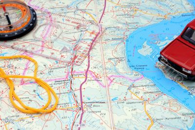 Fragment of a map with a compass and model of the automobile