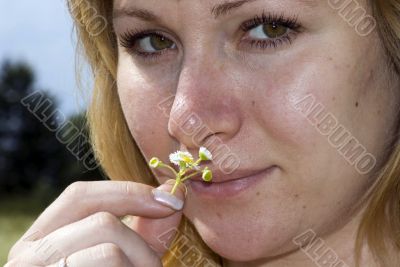 Girl smelling medical camomile