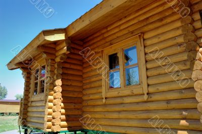 Wall of a wooden house with windows.