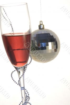 christmas ball and glass of wine