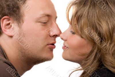 Portrait of young kissing couple.