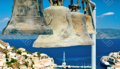 Four big bells against blue sea