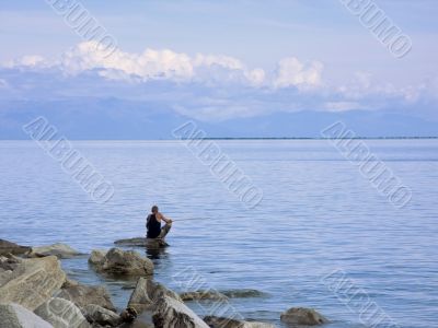 fisherman ashore lake