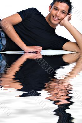 Friendly Indonesian young man lying down