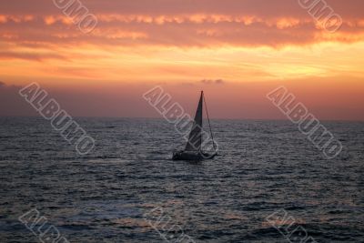The sea, yacht and clouds on a sunset