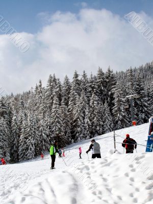 Skiers on mountain slopes