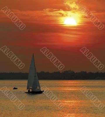 Yacht sailing in sunset