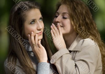 two whispering girlfriends
