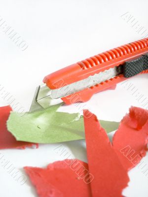 Knife and pieces of colored paper