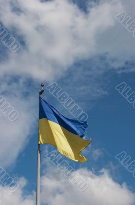 Ukrainian state flag upon blue sky