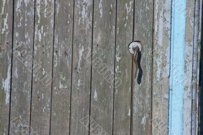  	Aged door handle on wooden entrance door