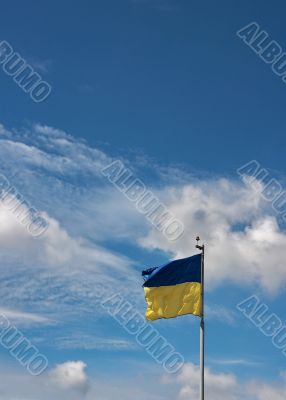 Ukrainian state flag upon blue sky