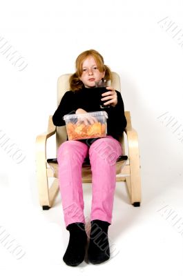 little girl is eating in her chair