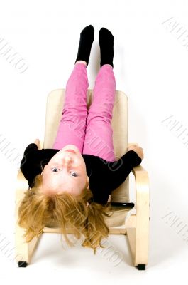 little girl is hanging upsite down