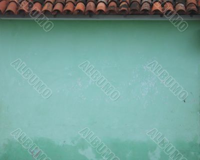 green wall and clay roof