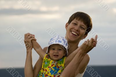 Happy mother and daughter playing together