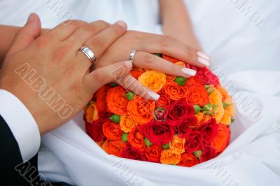 Newlywed couple holding hands