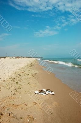 Beautiful seashore with the slippers