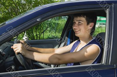 Young men driving a car