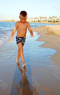 small boy on the beach of sea