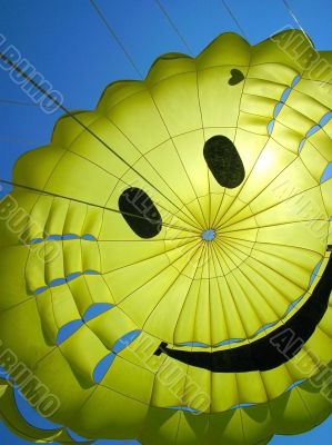 yellow fun parachute with smiling person