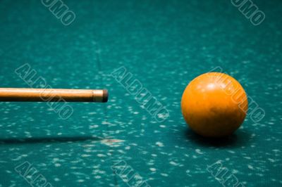 Billiard cue and yellow sphere