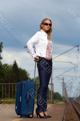 tired beautiful young lady with big suitcase