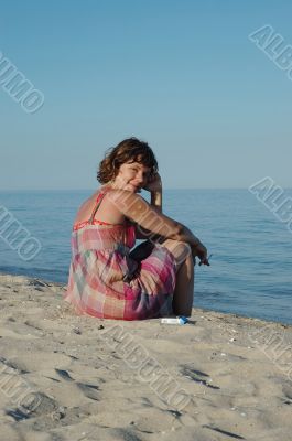 Young woman sitting on the seashore
