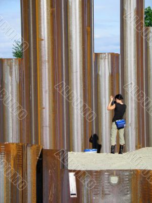 girl taking pictures of metal girders