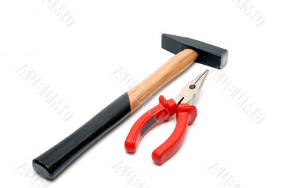 Hammer and flat-nose pliers with red handles isolated over white background