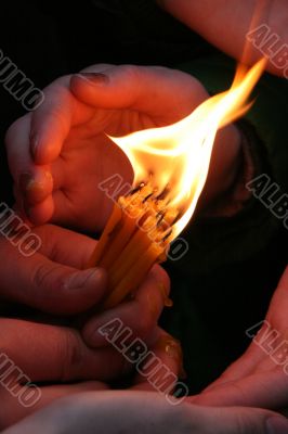 Flaming candle upon palms protection