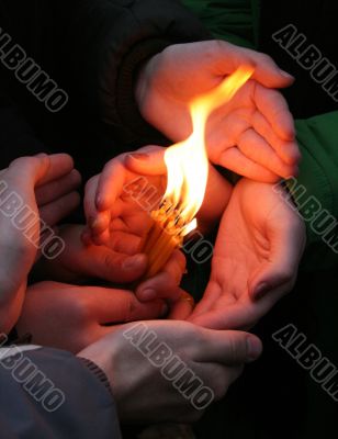 Flaming candle upon palms protection