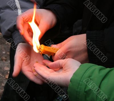Flaming candle upon palms protection