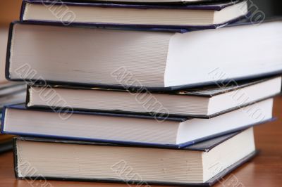  	Stack of new books with hard cover spine