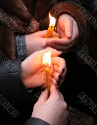 Flaming candle upon palms protection