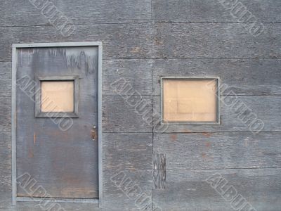 old grey barricaded door