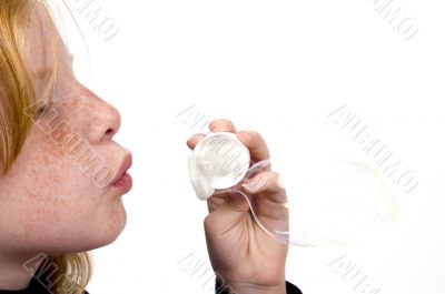 little girl is blowing bubbles