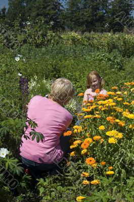 elderly woman is taking photos of girl (focus on girl)
