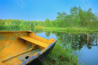 boat with holey on lake under blue sky