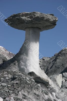 Stone on ice pillar