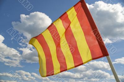 The orange striped flag is yellow.